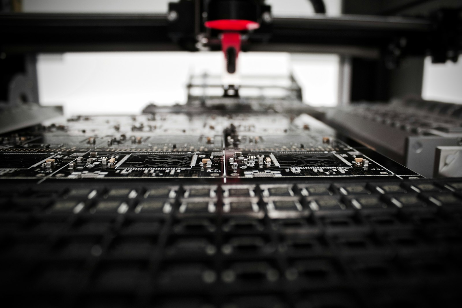 Engineer using digital calipers to measure a white 3D printed part